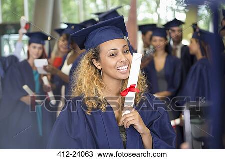 Stock Image - Portrait of university student after graduation ceremony. Fotosearch