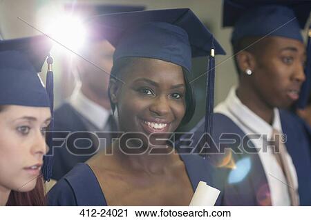 Portrait of university student holding diploma during graduation ceremony View Large Photo Image Stock Image - Portrait of university student holding diploma during graduation ceremony. Fotosearch