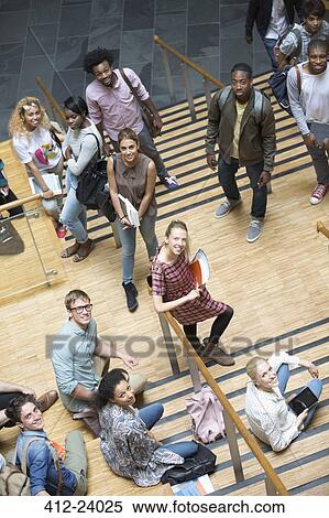 Stock Photography - Portrait of university students standing on staircase. Fotosearch
