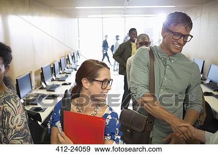 Stock Photo - Professor greeting university students in classroom. Fotosearch