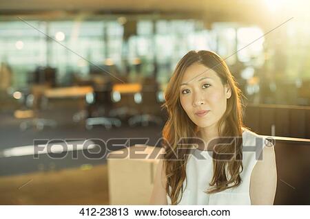 Serious businesswoman in office View Large Photo Image Stock Image - Serious businesswoman in office. Fotosearch