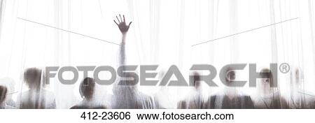 Stock Photograph - Silhouette of people behind transparent curtain, one person rising hand. Fotosearch