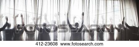 Silhouette of people raising hands behind transparent curtain View Large Photo Image Stock Photo - Silhouette of people raising hands behind transparent curtain. Fotosearch