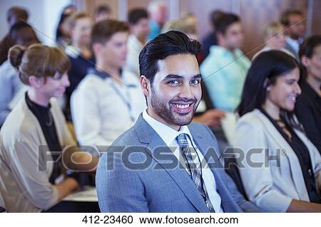 Smiling businessman sitting in conference room and looking at camera View Large Photo Image Stock Image - Smiling businessman sitting in conference room and looking at camera. Fotosearch