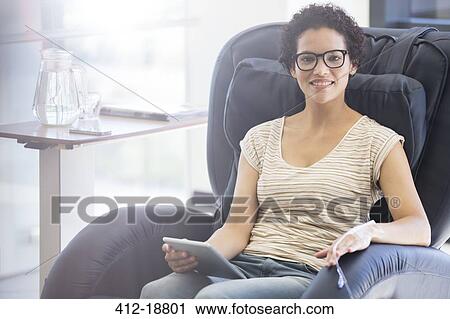 Smiling patient holding tablet pc, undergoing medical treatment in outpatient clinic View Large Photo Image Stock Image - Smiling patient holding tablet pc, undergoing medical treatment in outpatient clinic. Fotosearch