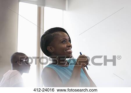 Smiling university student in blue top at seminar View Large Photo Image Stock Photograph - Smiling university student in blue top at seminar. Fotosearch