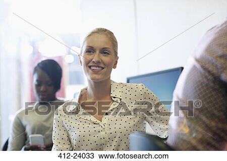 Smiling university student listening to seminar, young woman texting in background View Large Photo Image Stock Image - Smiling university student listening to seminar, young woman texting in background. Fotosearch