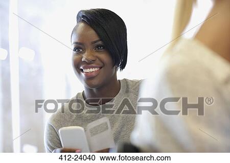 Smiling university student using smartphone at seminar View Large Photo Image Stock Image - Smiling university student using smartphone at seminar. Fotosearch