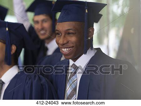 Smiling university students standing outdoors during graduation ceremony View Large Photo Image Stock Image - Smiling university students standing outdoors during graduation ceremony. Fotosearch
