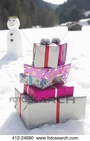 Stack of Christmas gifts in snow View Large Photo Image Stock Image - Stack of Christmas gifts in snow. Fotosearch