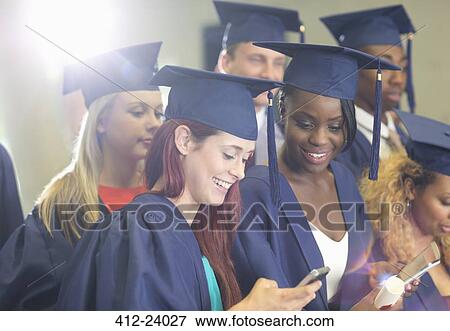 Stock Photo - Students texting during graduation ceremony. Fotosearch