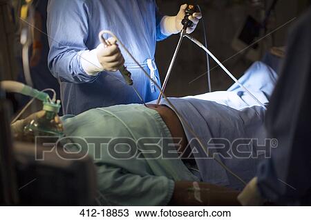 Surgeon holding medical tools and performing laparoscopic surgery in operating theater View Large Photo Image Stock Image - Surgeon holding medical tools and performing laparoscopic surgery in operating theater. Fotosearch