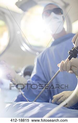 Surgeon performing laparoscopic surgery in operating theater View Large Photo Image Stock Photography - Surgeon performing laparoscopic surgery in operating theater. Fotosearch