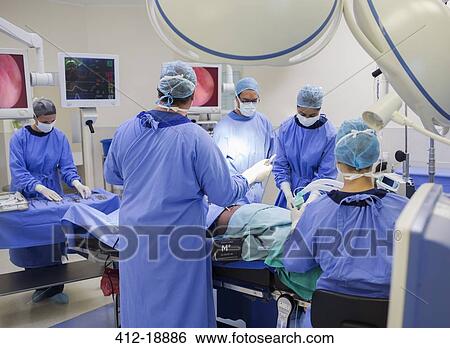 Team of doctors performing surgery in operating theater View Large Photo Image Stock Photograph - Team of doctors performing surgery in operating theater. Fotosearch