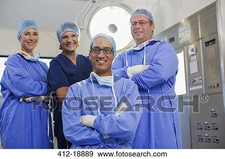 Team of doctors wearing surgical clothing in operating theater View Large Photo Image Stock Photo - Team of doctors wearing surgical clothing in operating theater. Fotosearch