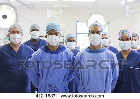 Stock Image - Team of surgeons in operating theater. Fotosearch