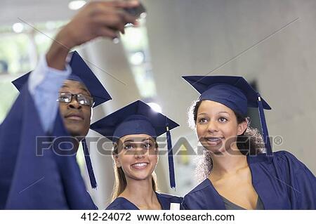 Three university students taking selfie after graduation ceremony View Large Photo Image Stock Image - Three university students taking selfie after graduation ceremony. Fotosearch