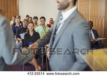 Two businessmen shaking hands during conference in conference room View Large Photo Image Picture - Two businessmen shaking hands during conference in conference room. Fotosearch