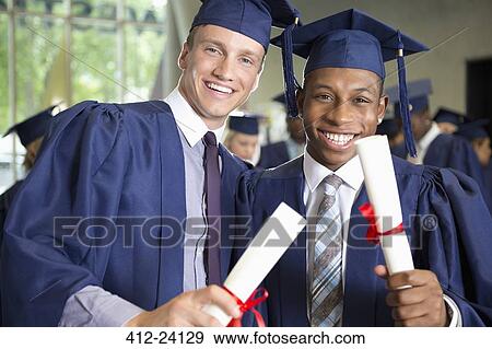 Two laughing male students in graduation clothes holding diplomas View Large Photo Image Stock Photo - Two laughing male students in graduation clothes holding diplomas. Fotosearch