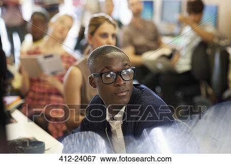 University student listening to IT seminar, students sitting in background View Large Photo Image Stock Photo - University student listening to IT seminar, students sitting in background. Fotosearch