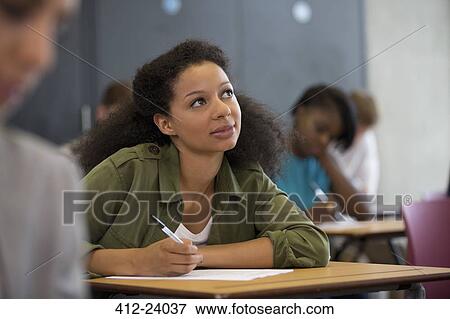 University student looking up during exam View Large Photo Image Stock Photo - University student looking up during exam. Fotosearch