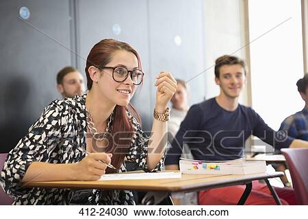 University student taking notes and listening during seminar in classroom View Large Photo Image Stock Image - University student taking notes and listening during seminar in classroom. Fotosearch
