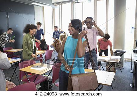 University students packing their bags and leaving classroom View Large Photo Image Stock Image - University students packing their bags and leaving classroom. Fotosearch