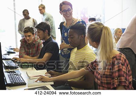 University students studying on computers and discussing View Large Photo Image Picture - University students studying on computers and discussing. Fotosearch