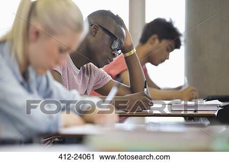 Stock Image - University students taking exam. Fotosearch