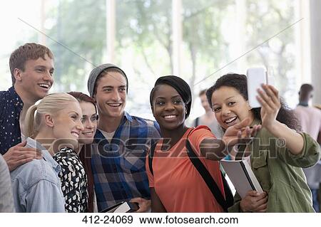University students taking selfie in corridor during break View Large Photo Image Stock Photo - University students taking selfie in corridor during break. Fotosearch