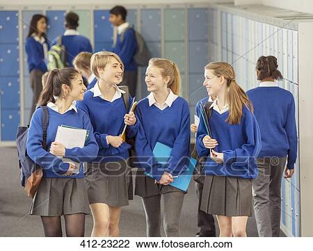 Cheerful female students wearing blue school uniforms walking in locker room View Large Photo Image Stock Image - Cheerful female students wearing blue school uniforms walking in locker room. Fotosearch