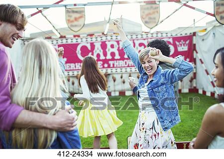 Picture - Cheerful woman celebrating victory in game in amusement park. Fotosearch