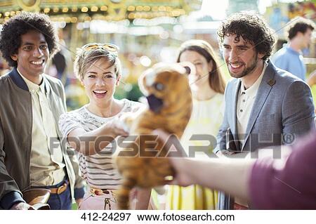 Cheerful woman reaching for soft toy in amusement arcade View Large Photo Image Stock Photo - Cheerful woman reaching for soft toy in amusement arcade. Fotosearch