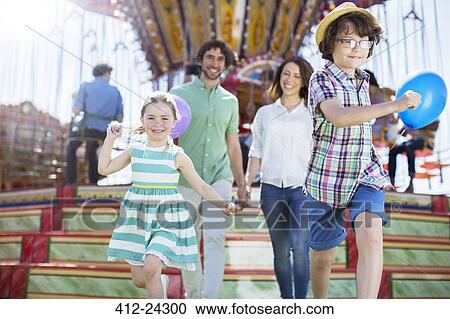 Children running in front of carousel, parents following them View Large Photo Image Stock Image - Children running in front of carousel, parents following them. Fotosearch