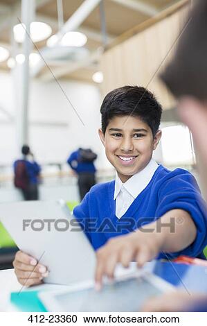 Elementary school boy with digital tablet View Large Photo Image Stock Image - Elementary school boy with digital tablet. Fotosearch