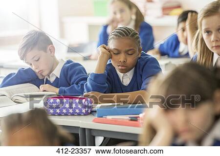 Stock Photo - Elementary school children asleep and bored in classroom. Fotosearch