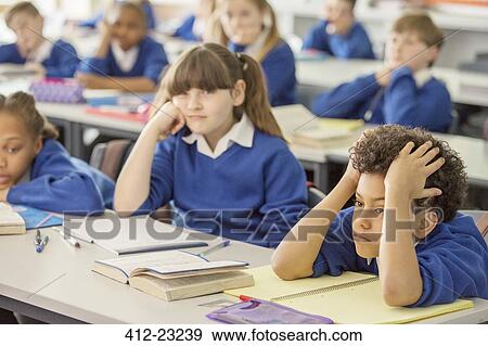 Elementary school children bored in classroom View Large Photo Image Stock Photo - Elementary school children bored in classroom. Fotosearch