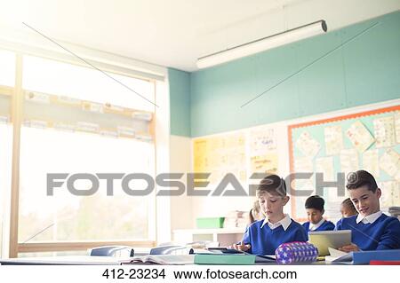 Elementary school children in classroom during lesson View Large Photo Image Picture - Elementary school children in classroom during lesson. Fotosearch
