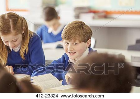 Elementary school children in classroom during lesson View Large Photo Image Picture - Elementary school children in classroom during lesson. Fotosearch