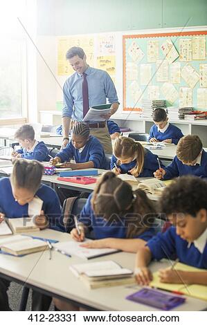 Elementary school children in classroom during lesson View Large Photo Image Stock Image - Elementary school children in classroom during lesson. Fotosearch
