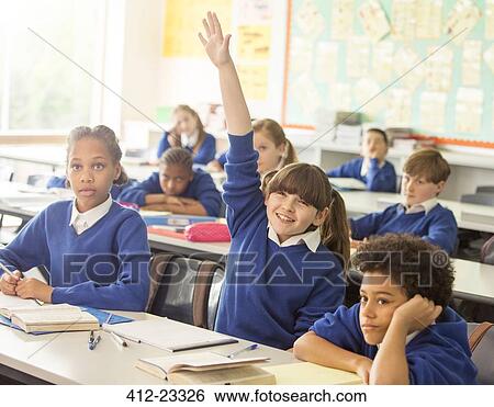 Elementary school children in classroom during lesson, smiling girl raising hand View Large Photo Image Stock Photograph - Elementary school children in classroom during lesson, smiling girl raising hand. Fotosearch