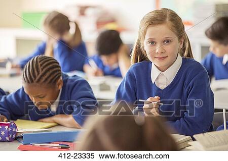 Elementary school children in classroom during lesson View Large Photo Image Stock Photography - Elementary school children in classroom during lesson. Fotosearch