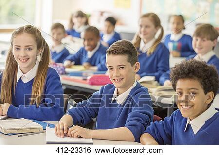 Elementary school children smiling in classroom View Large Photo Image Stock Photograph - Elementary school children smiling in classroom. Fotosearch