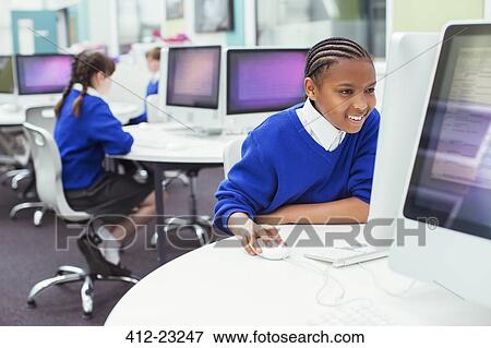 Elementary school children working with computers during IT lesson View Large Photo Image Stock Photo - Elementary school children working with computers during IT lesson. Fotosearch