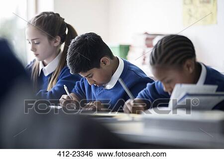Elementary school children writing in classroom View Large Photo Image Stock Photograph - Elementary school children writing in classroom. Fotosearch