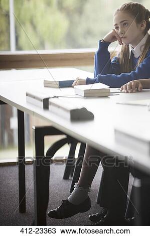 Elementary school girl looking bored in classroom View Large Photo Image Stock Image - Elementary school girl looking bored in classroom. Fotosearch