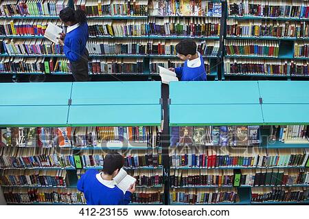 Stock Photography - Elevated view of high school students browsing books in library. Fotosearch
