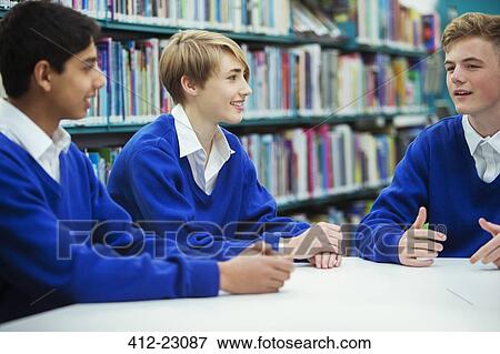 Female and male students discussing in college library View Large Photo Image Stock Photo - Female and male students discussing in college library. Fotosearch