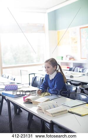 Female pupil sitting in classroom with tablet pc View Large Photo Image Stock Image - Female pupil sitting in classroom with tablet pc. Fotosearch