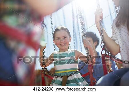 Girl smiling on carousel in amusement park View Large Photo Image Stock Photo - Girl smiling on carousel in amusement park. Fotosearch